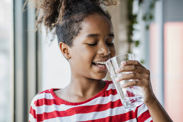 istock Cute girl drinking water 1344126759