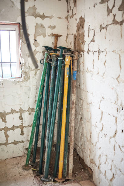 istock Telescopic props piled up on the wall of a house under construction 1344127080