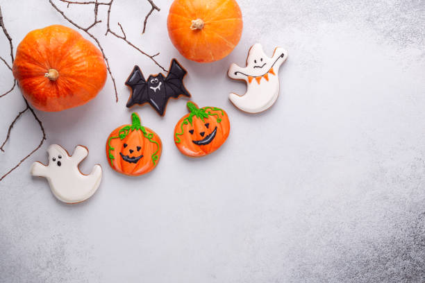 istock Fresh gingerbread cookies, Halloween decorations, paper bat on stone background. Halloween concept 1344131089