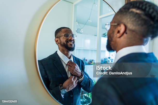 Young Businessman Motivates Himself In Front Of A Mirror Stock Photo - Download Image Now