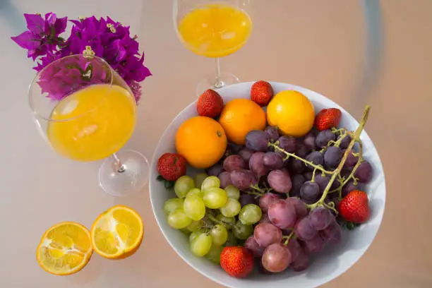 fresh homemade drinks, orange juice and delicious sweet grapes for breakfast, healthy mediterranean lifestyle
