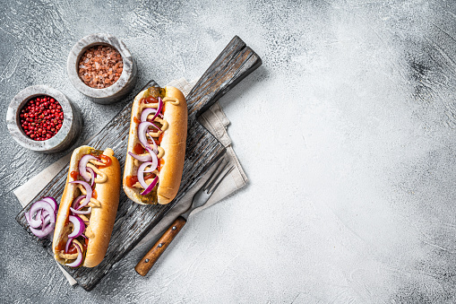 Vegetarian hot dog with with toppings and meatless sausage. White background. Top view. Copy space