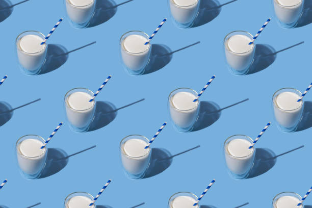istock World Milk Day. Pattern on a blue background. A glass of milk with a straw. Sample. Package. Layout 1344138920