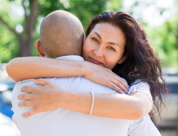 istock Woman and man hugging in parking lot 1344139193