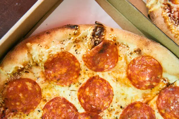 Photo of Delicious fresh pepperoni pizza in a box close up