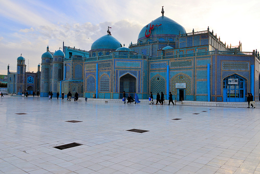Mazar-i-Sharif, Balkh province, Afghanistan: Shrine of Ali (Hazrat Ali Mazar), richly decorated east facade with twin domes and the museum entrance on the right - aka Blue Mosque or Rauza, considered (mainly by the Afghans) as the burial place of Ali ibn Abi Talib, cousin of Mohammed. He was the first male follower of Muhammad and married his daughter Fatima. Ali was the fourth Rightly Guided caliph and the first Imam of Shia Muslims.