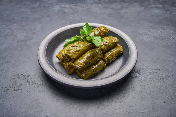 istock Delicious stuffed grape leaves dolma with parsley in black plate 1344141737