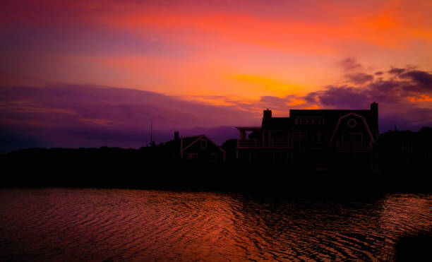 paesaggio notturno vibrante lunatico con nuvole rosa e rosse sulla città balneare di falmouth, massachusetts - cape cod new england sea marsh foto e immagini stock