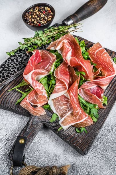 istock Sliced Spanish Jamon Serrano ham or Prosciutto Crudo Parma ham. White background. Top view 1344146705