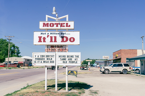 Atwood, Kansas - July 28, 2021: Sign for the It'll Do Motel - it's not a Hilton in the rural town