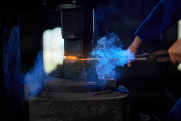 istock Craftsman putting heated metal under press machine 1344146867