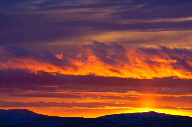 Colorful Sunset in the Mountains.  Vibrant oranges and reds in this gorgeous sunset in the Selkirk Mountains, Canada.  Captured as a 14-bit Raw file. Edited in ProPhoto RGB color space.