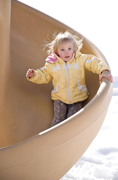 istock Little Girl Playing on Slide at Playground 134415606