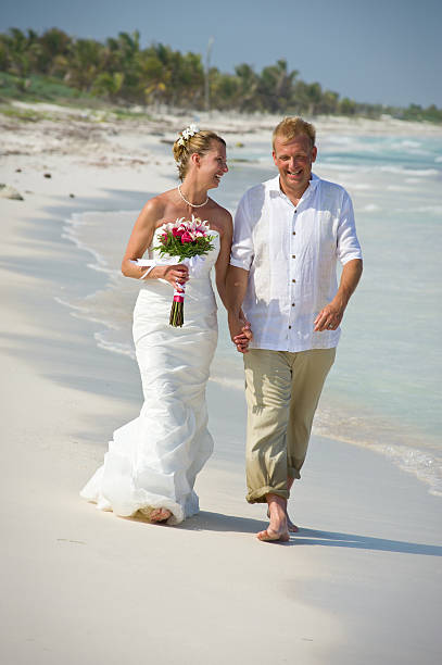 istock Bride and Groom Holding Hands on Scenic Beach 134415862