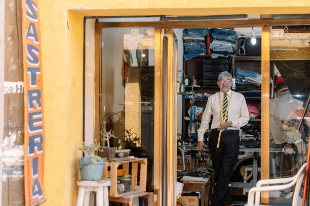 istock Portrait of an old Mexican tailor working with sewing machine 1344160001