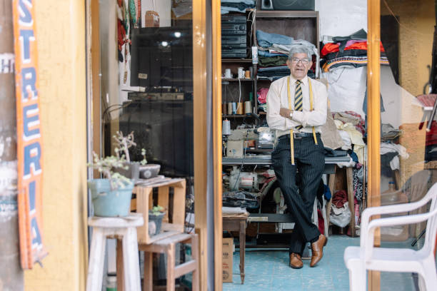 istock Portrait of an old Mexican tailor working with sewing machine 1344160002