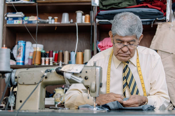 istock Aged Mexican tailor sewing by hand 1344160057