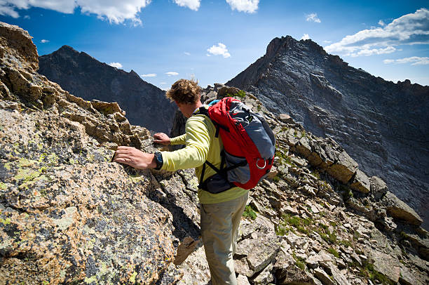 istock Solo Male Climber Hiking High on Mountain Peak 134416466