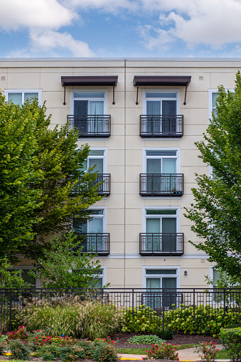 Six apartment balconies with trees and blue skies