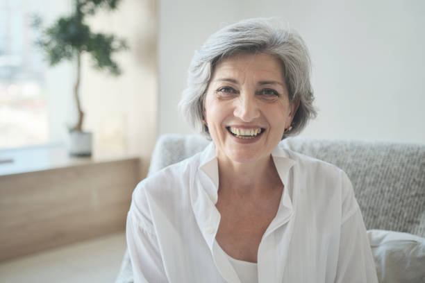 istock Smiling 60s older senior middle-aged adult lady using video conference calling 1344169484