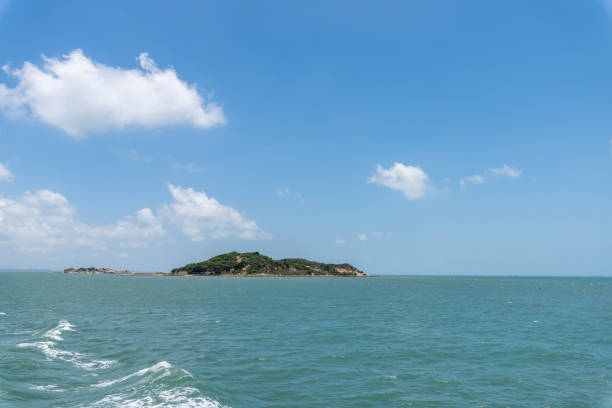 istock The sea and coastline under blue sky and white clouds 1344171918