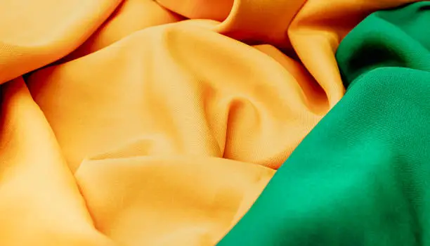 Photo of Brazil background. Fabric texture background with green and yellow colors reminding the colors of the Brazilian flag.