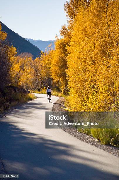 Woman Cycles With Bike On Recreation Path Stock Photo - Download Image Now - Bicycle Lane, Carbondale - Colorado, Adult