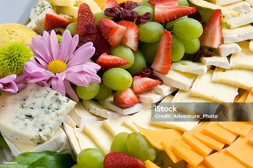 Cheese and Fruit Tray Cheese and Fruit Tray.  Imported cheeses and fresh fruit appetizer display.  Prepared by world class chef.  ProPhoto RGB. Appetizer Stock Photo