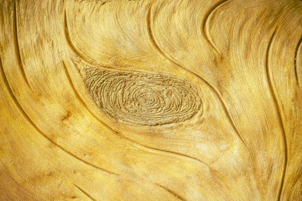 istock Gold concrete plastering wall texture with natural eye wood patterns for colorful background 1344181820