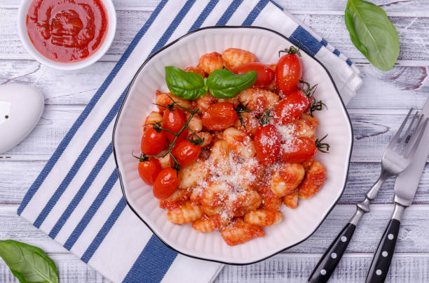 istock Gnocchi with tomatoes, red sauce, cheese and basil leaves 1344189157