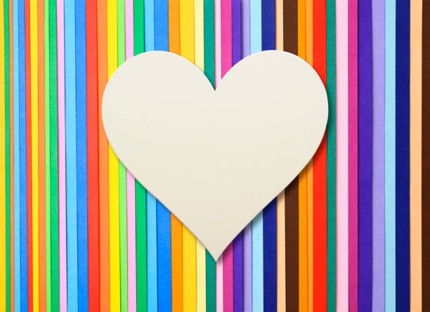 istock Blank white paper heart on multi colored paper 1344189307