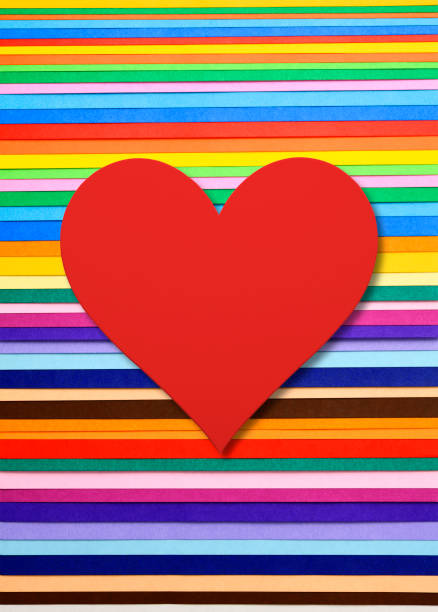 istock Red paper heart on multi colored paper 1344189308