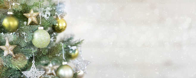 Christmas  tree in green decorations on a white Background with Bokeh. Very shallow depth.