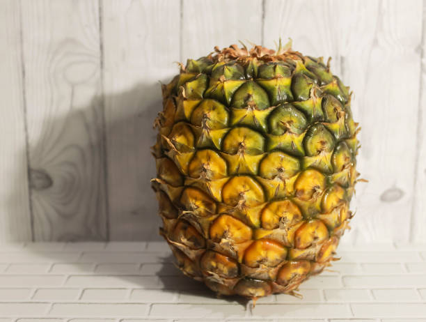A Pineapple and wooden wall background