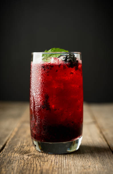 istock Blackberry cocktail with crushed ice on the rustic wooden background. Selective focus. Shallow depth of field. 1344200549