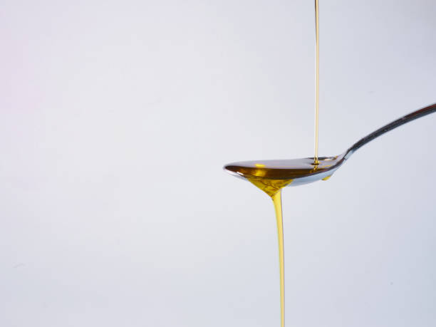 istock Pouring fresh olive oil into spoon 1344200594