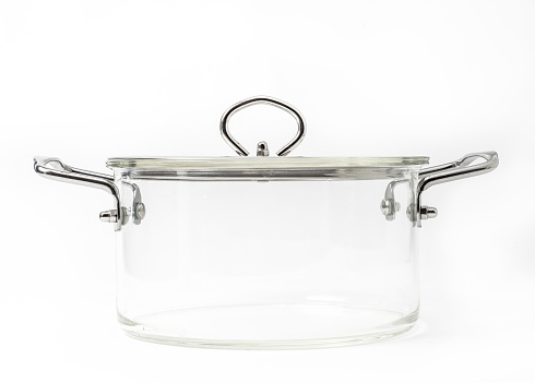Beautiful glass pot with stainless steel handle, glass lid with shinning stainless steel. Whole pot made from hight quality glass. Isolated glass pot on white background, front view.