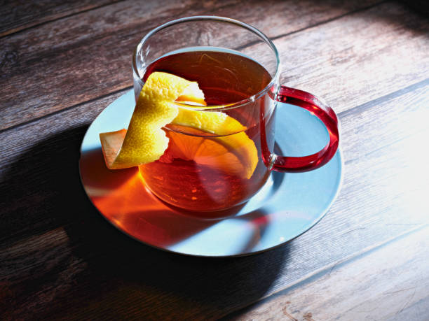 istock tea with lemon on wooden table and blue dish 1344201612