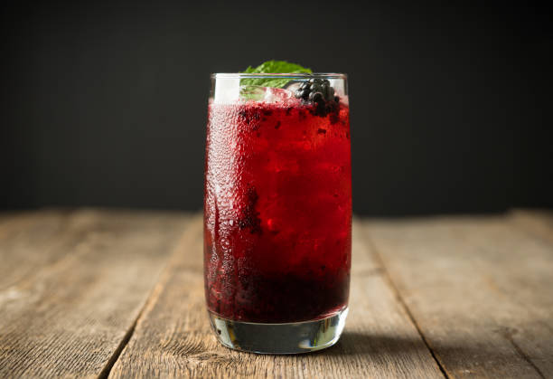 istock Blackberry cocktail with crushed ice on the rustic wooden background. Selective focus. Shallow depth of field. 1344203029
