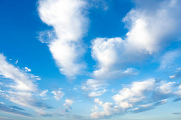 Stunning view of some white clouds moving across a blue sky. Natural background, Sardinia, Italy. stock photo
