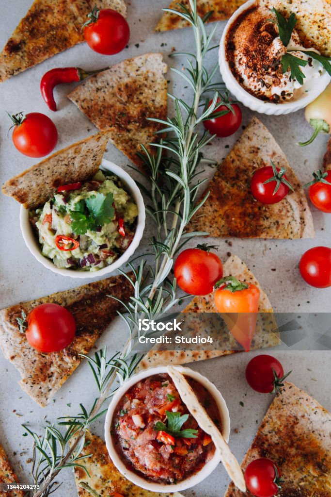 Tortilla chips with sauces Nacho Chips with Salsa decorated on a table. Canape Stock Photo