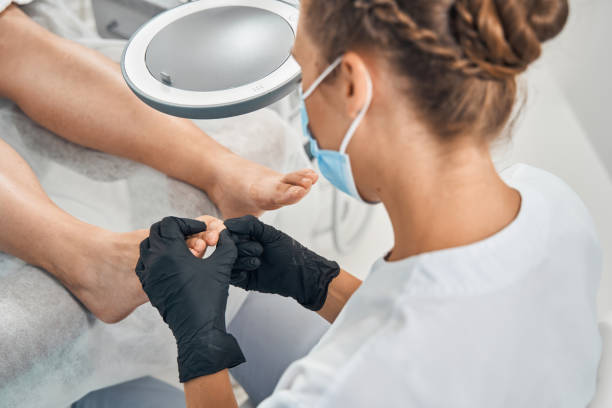 Competent podologist examining the quality of nails