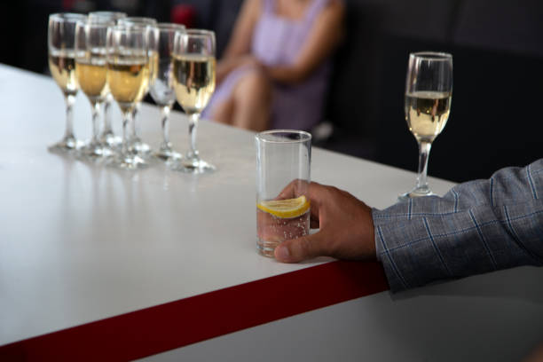 istock male hand holding drinking glass 1344205788
