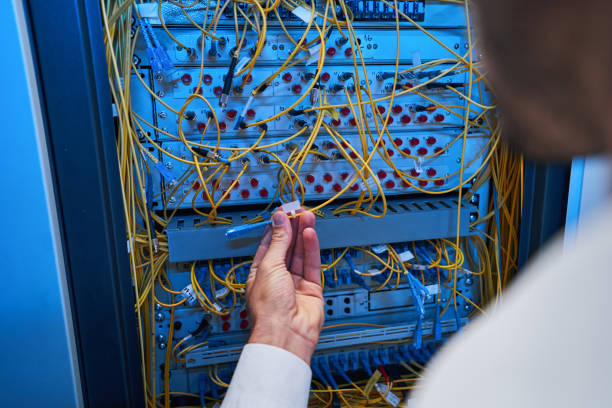 istock Fiber-optic cable in hand of server administrator 1344207878