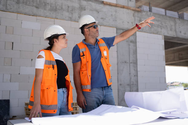 istock Civil Engineer and Architect Checking The Project According To The Blueprint Drawings At The Construction Site 1344207984