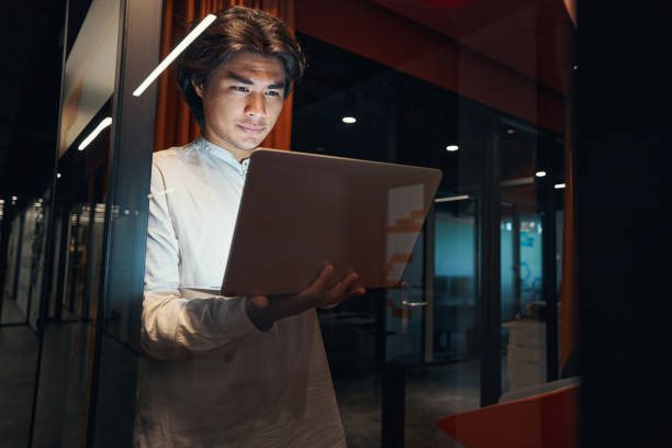istock Man looking at laptop with calmness and gladness 1344208721