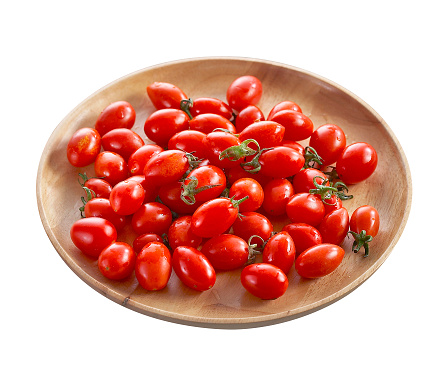 Group of tomato in wooden tray isolated on white background