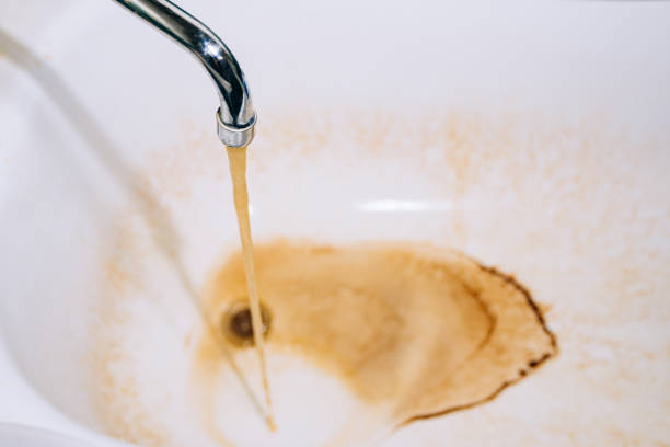 istock Rusty water flows from the faucet in the bathroom 1344209832