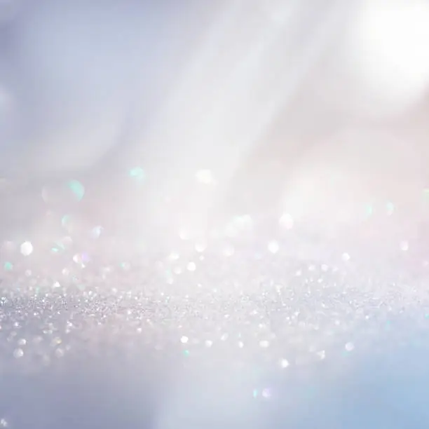 Photo of Winter gentle sparkle snowy blurry background in light blue pink tones.