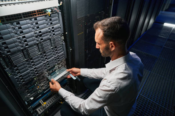 istock Professional it specialist working in data center 1344210193
